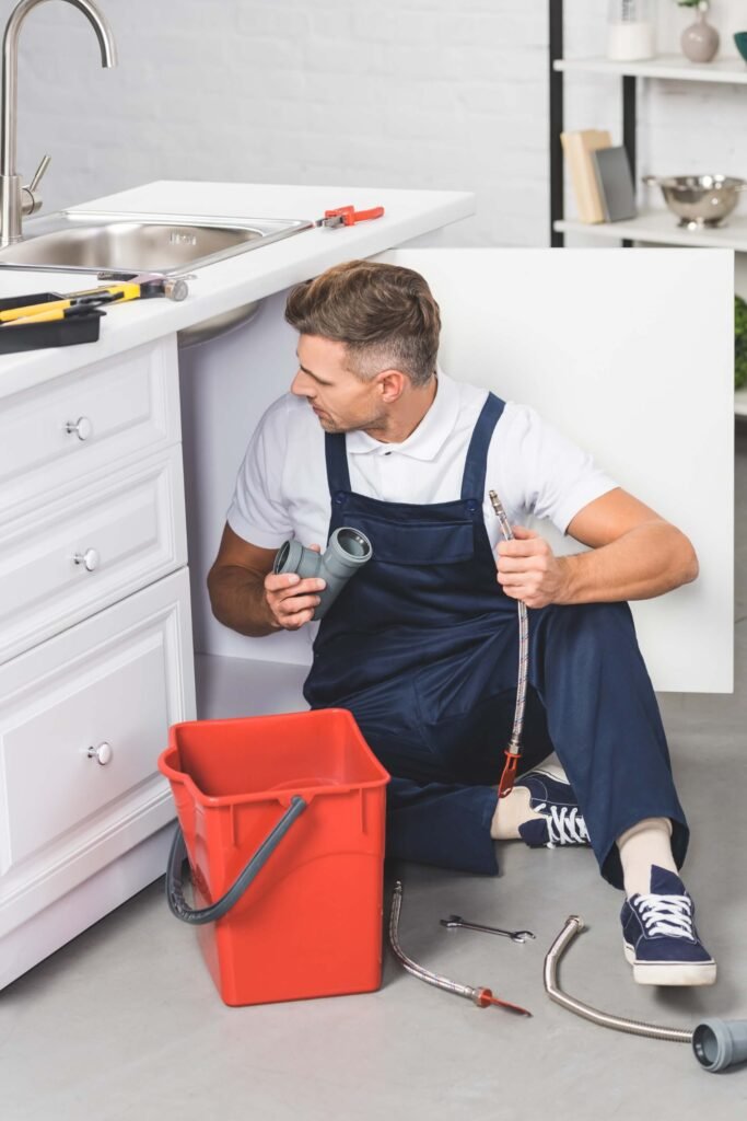 adult repairman with red plastic bucket holding pi 2024 11 15 00 54 07 utc